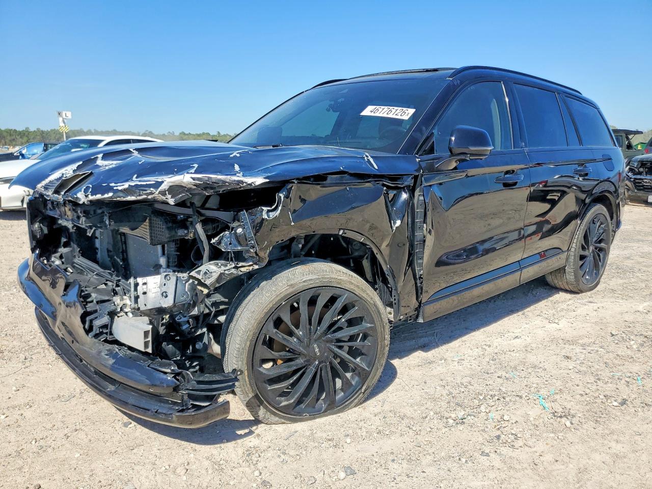 Actual auction photo: black Lincoln Aviator with crushed hood, damaged left fender and missing left headlight